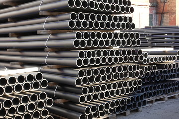 Plastic pipes in stock of finished products stacked in packs