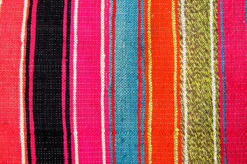 Striped colorful background. Handmade carpet.
