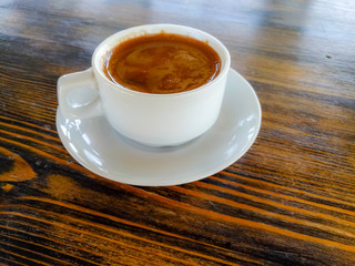 a Cup of natural black coffee on a wooden table in a seaside cafe