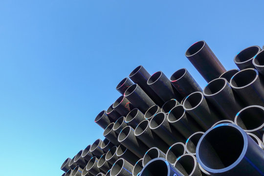 Plastic pipes in stock of finished products stacked in packs