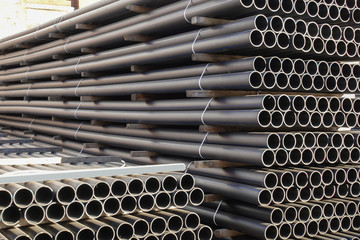 Plastic pipes in stock of finished products stacked in packs