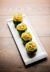 Stuffed capsicum or bharwa shimla mirchi is a popular Indian main course recipe. Served in a plate over moody background. Selective focus