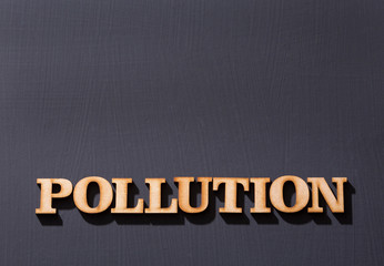 Word pollution in wooden letters. Wooden background