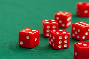 Red dices on green poker gaming table in casino. Concept online gambling