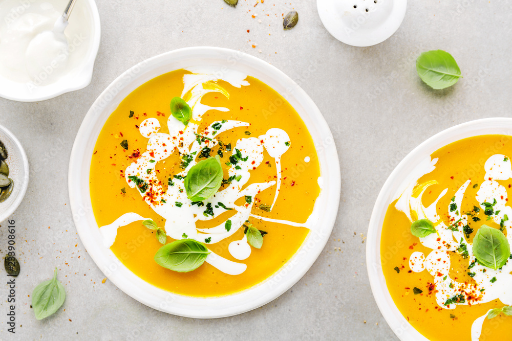 Wall mural Pumpkin creamy soup served in bowl