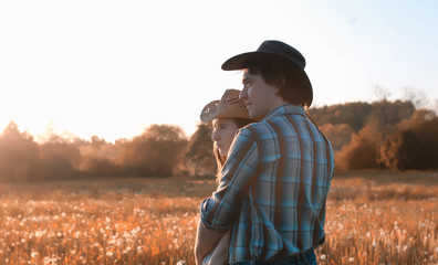 man and a girl are walking in the autumn
