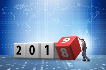 Businessman employee rotating cube to reveal number 2019