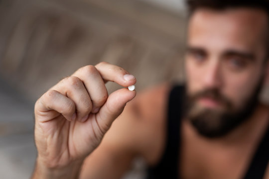 Man taking ecstasy pill