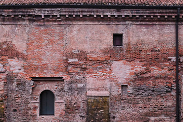 Fototapeta na wymiar View on an ancient building made of red bricks in Bologna, Italy. 