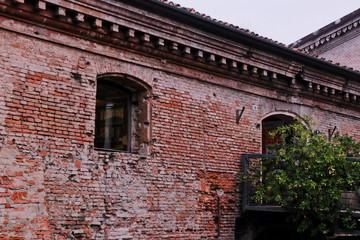 View on an ancient building made of red bricks in Bologna, Italy.  