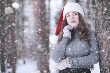 Girl in a winter park in snowfall