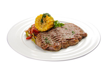 Beef steak with corn and vegetables. On a white background