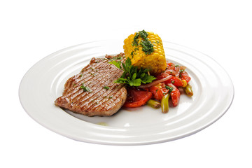 Beef steak with corn and vegetables. On a white background