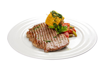 Beef steak with corn and vegetables. On a white background