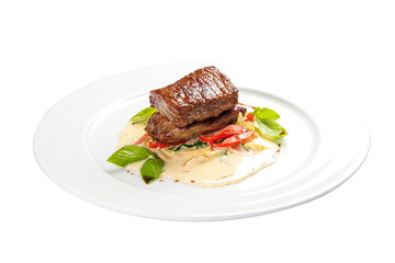 Veal medallion with vegetables. On a white background