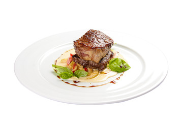 Veal medallion with vegetables. On a white background