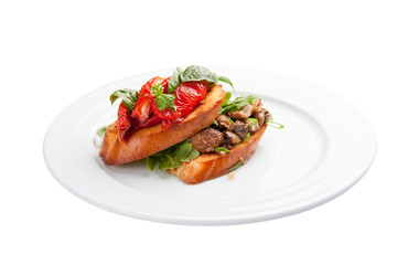 Bruschetta with tomatoes and mushrooms. On a white background