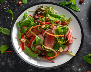 Spicy Beef Salad with Carrots, radish, bean sprouts, chilli, nuts and green mix