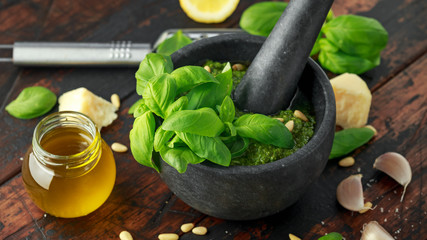Green Basil Pesto in marble mortar with parmesan cheese, pine nuts, garlic and lemon.