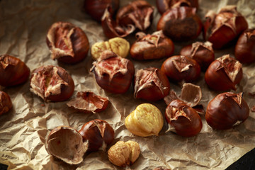 Roasted chestnuts served on crumpled paper