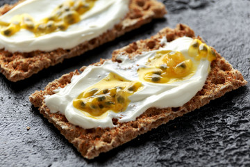 Rye breads with soy curd and maracuja, passion fruit. healthy breakfast