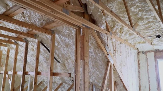 New home construction with installation of termal insulation installing at the attic the roof