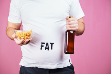 overeating, fast food, excess food, glutton, alcohol addiction, junk food. Fat obese man with...