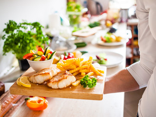Fish dish - fried fish fillet with vegetables and french fries