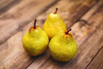 Fresh pears on a dark wooden table made of wood