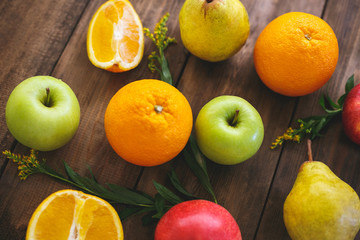 Juicy delicious fruits on the table out of wood a dark color