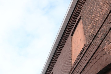 Boarded up vacant brick industrial building