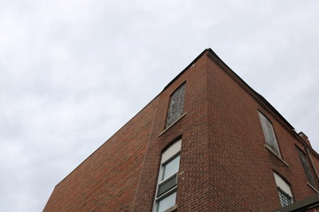 Boarded up vacant brick industrial building