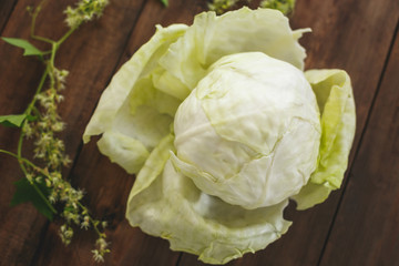 Fresh cabbage on a wooden table dark color