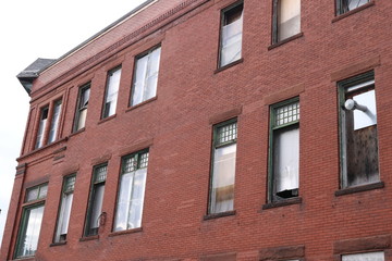 Fototapeta na wymiar Boarded up vacant brick industrial urban building