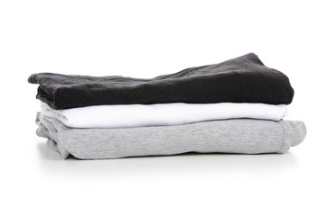 A stack of t-shirt gray black white on a white background. Isolation