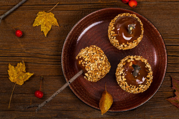 Caramel Apples on Wooden Background. Selective focus.
