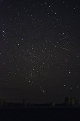 The rising of the constellation Orion over the road