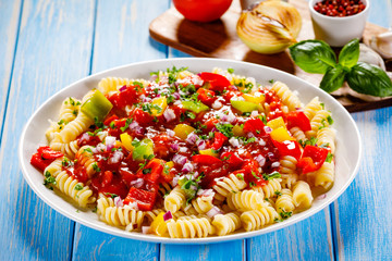 Pasta with vegetables on wooden background