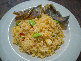 Selective focus of traditional fried rice consists of red chillies, Parkia speciosa and dried salted seven star Grouper fish.