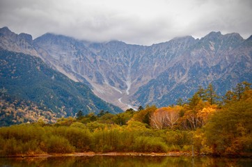 Natural landscape view of the autumn red-orange color forest with the mountain hill in Kamikochi,Matsumoto,Japan