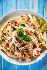 Pasta carbonara on wooden table