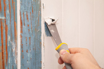 Scraping paint off a wall