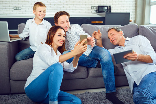 A Happy Family With A Laptop Is Having Fun In The Room