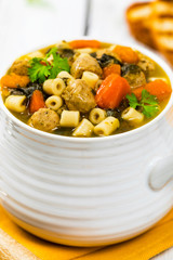 Soup with Meatballs, Carrots and Spinach in Chicken Broth. Selective focus. 