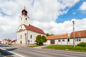 Fototapeta na wymiar Clouds over church in Trstin - a village in Slovakia