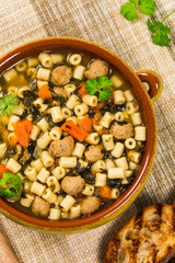 Soup with Meatballs, Carrots and Spinach in Chicken Broth. Selective focus. 