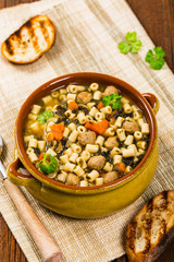 Soup with Meatballs, Carrots and Spinach in Chicken Broth. Selective focus. 