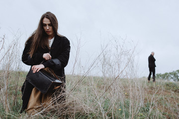 Atmospheric Portrait of a girl with a guy on the subject: parting, racking up, depression, longing,...