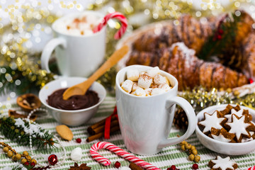 Christmas and New Year Background Breakfast with Croissants and Hot Cocoa with Marshmallows. Selective focus.