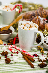 Christmas and New Year Background Breakfast with Croissants and Hot Cocoa with Marshmallows. Selective focus.